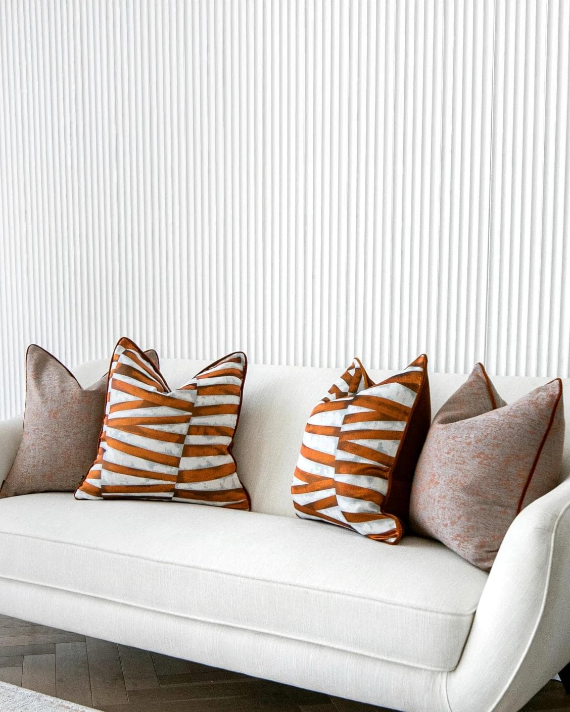 Alani Bundle cushion in orange, white and red, shown in a lifestyle right view as image 2