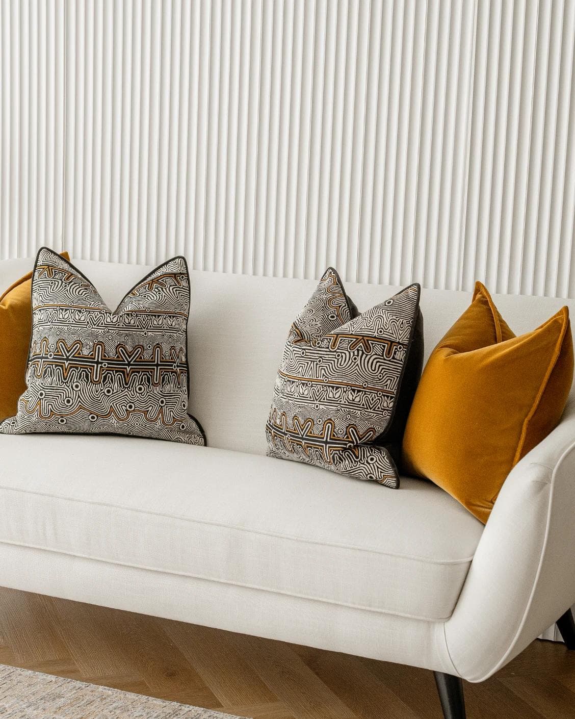 Adin Bundle cushion in orange, black and silver, shown in a lifestyle right view as image 2