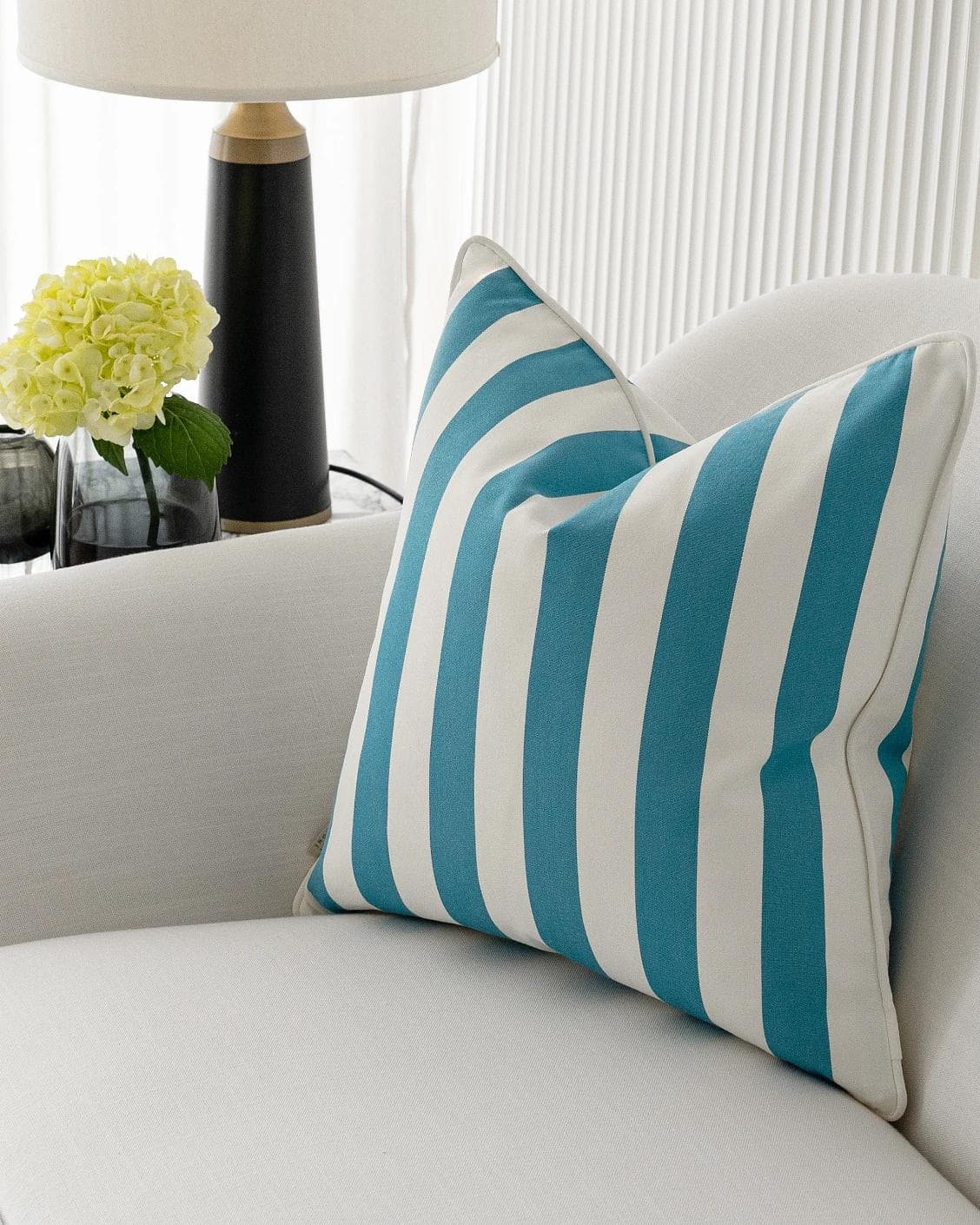Aelia Azure cushion in blue and soft ivory, shown in a lifestyle right view as image 2