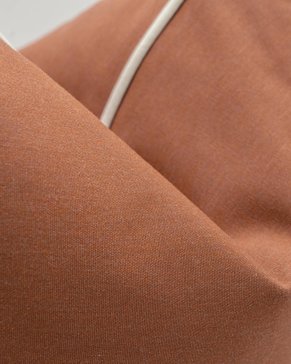 Aelia Clay cushion in rust, shown in a product close-up as image 6
