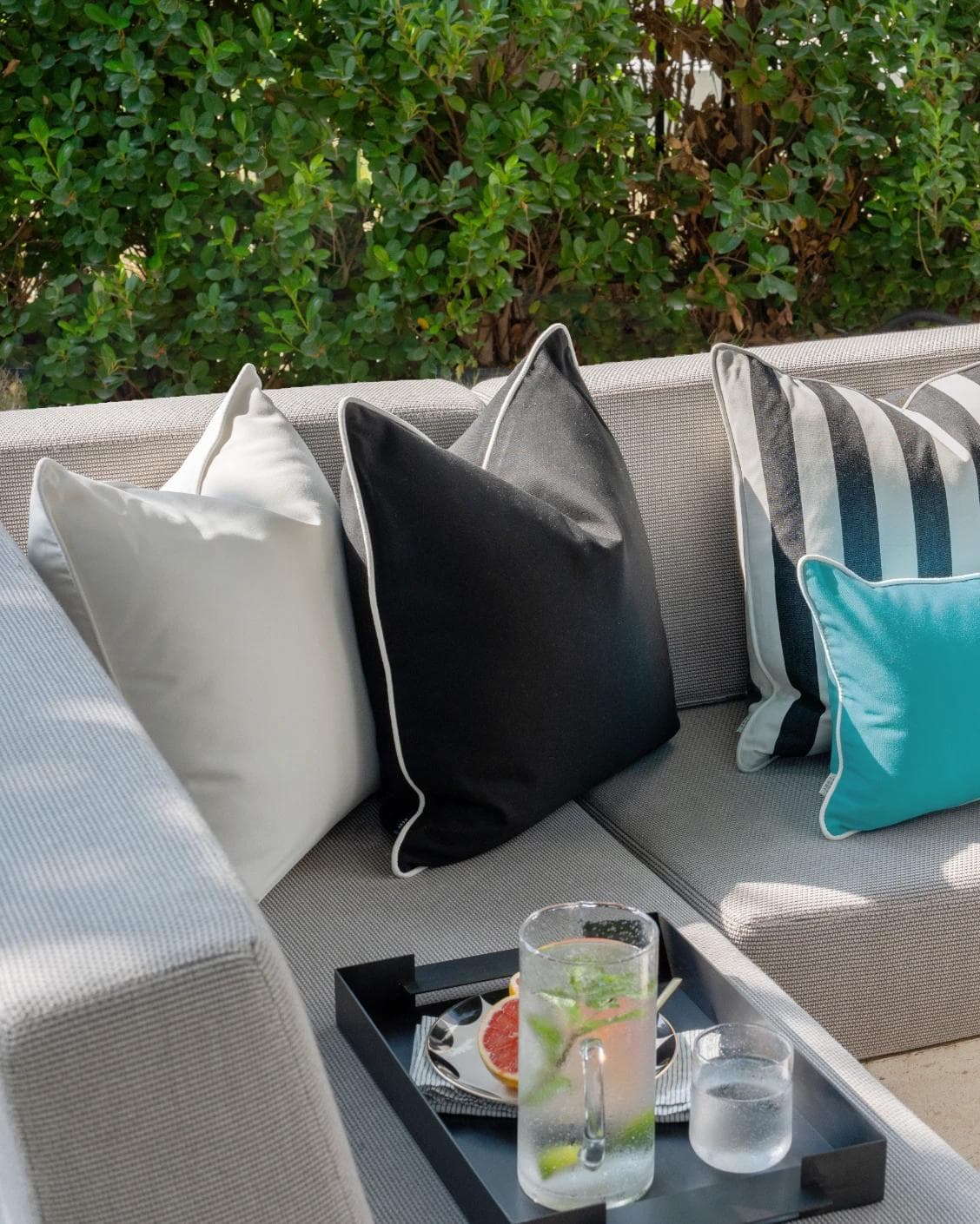 Aelius Bundle cushion in ivory, turquoise and black, shown in a lifestyle left view as image 2