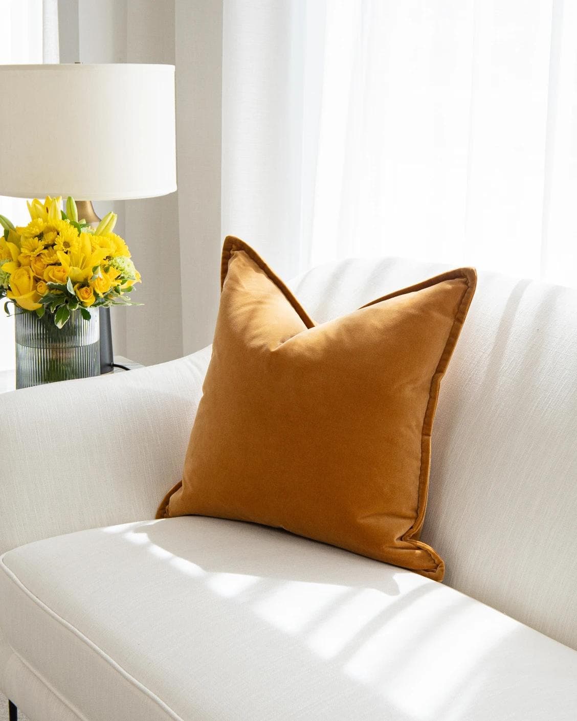 Alessandra Hodler cushion in orange, shown in a lifestyle top view as image 2