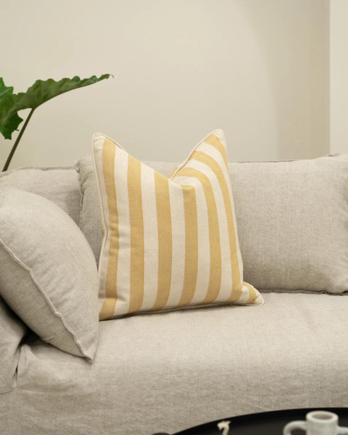 Ameline Barrymore cushion in yellow, shown in a lifestyle left view as image 2