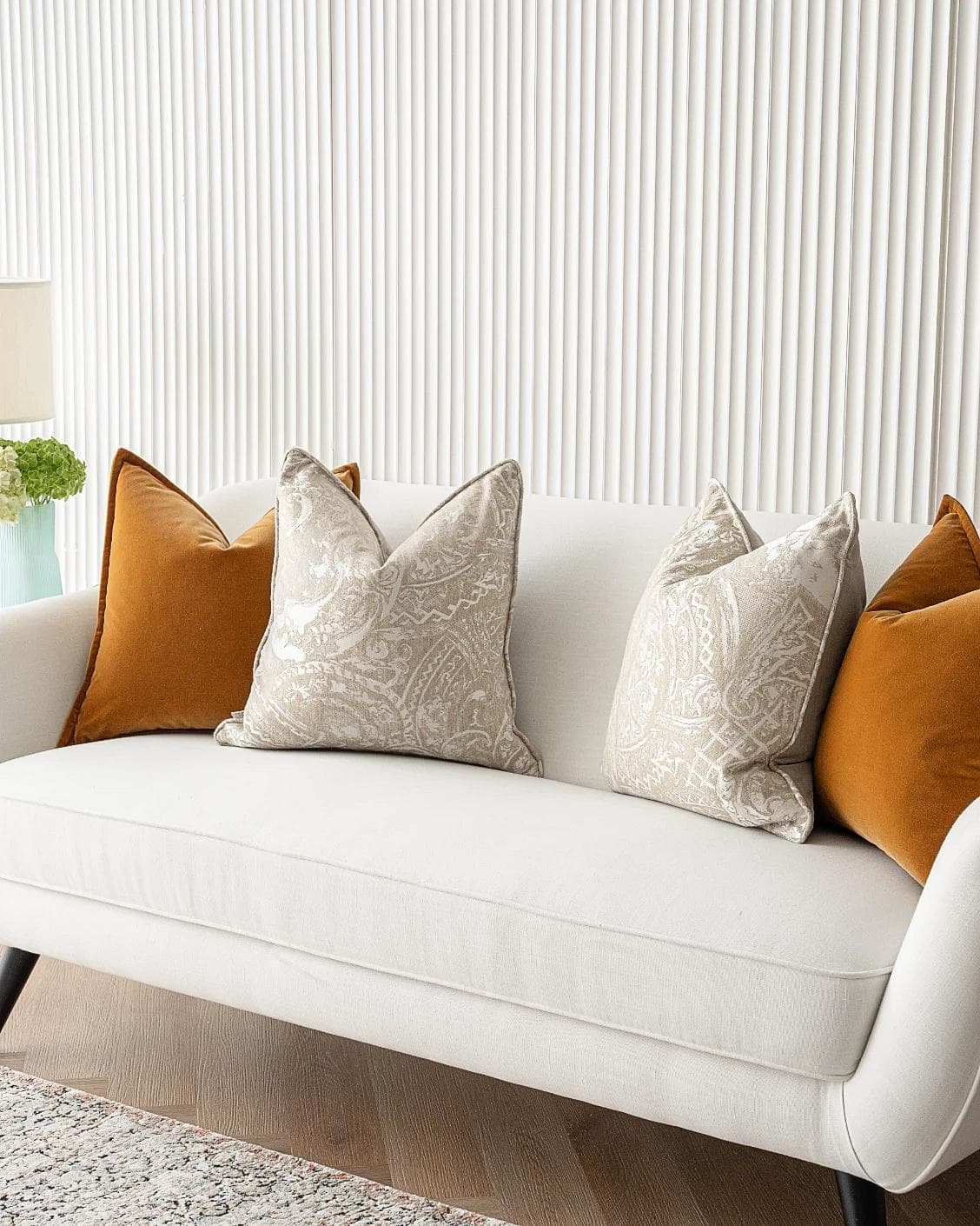 Amiya Bundle cushion in orange, beige and silver, shown in a lifestyle right view as image 2
