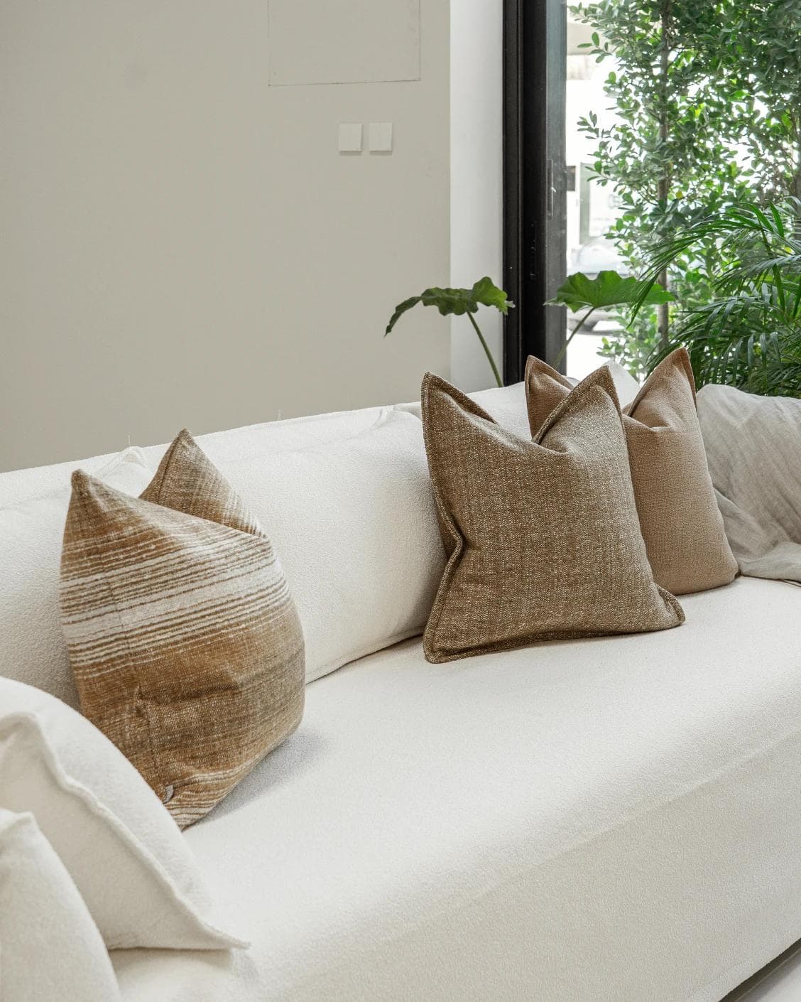 Aya Bundle cushion in brown, shown in a lifestyle left view as image 2
