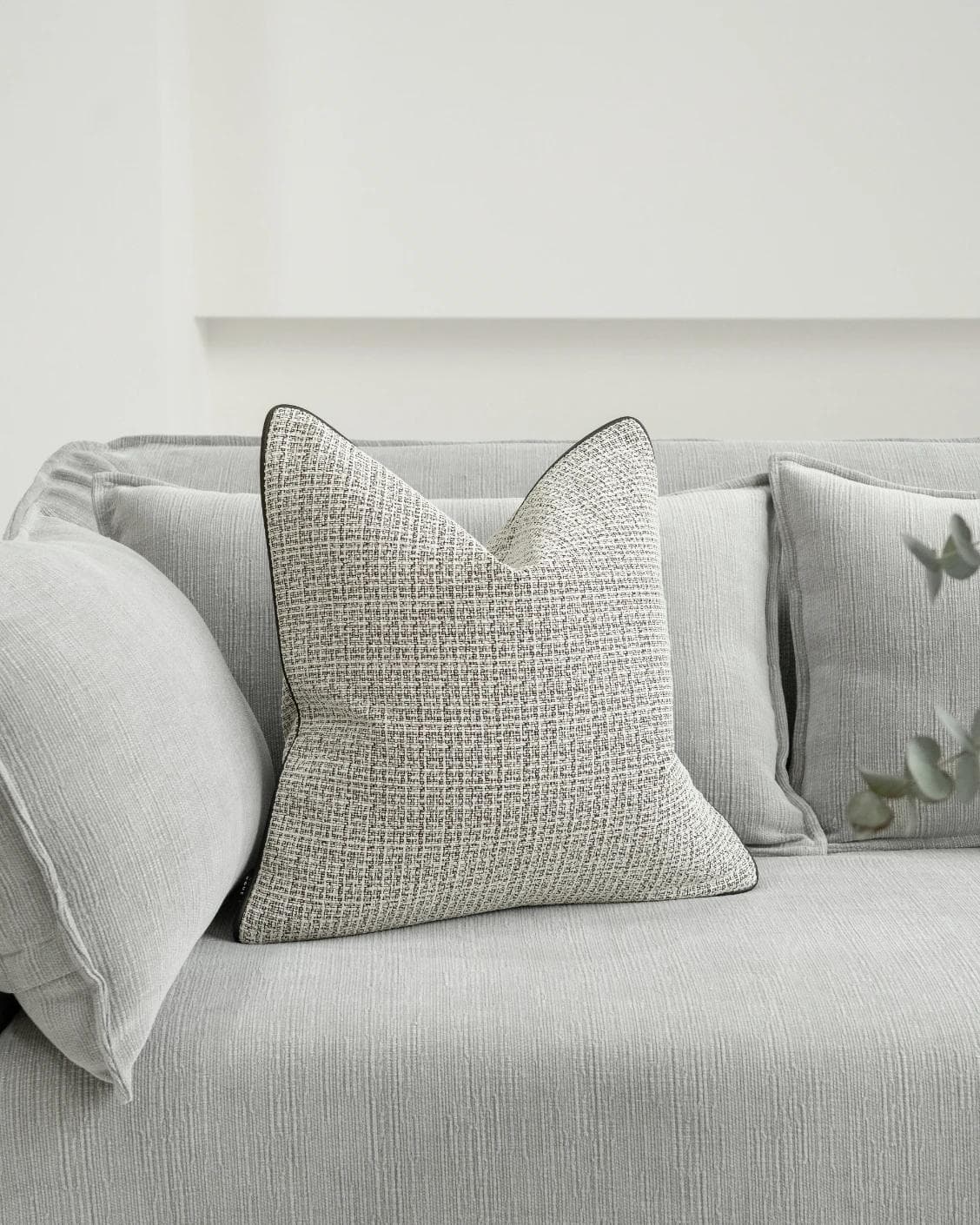 Cami Steele cushion in charcoal, shown in a lifestyle front view as image 2