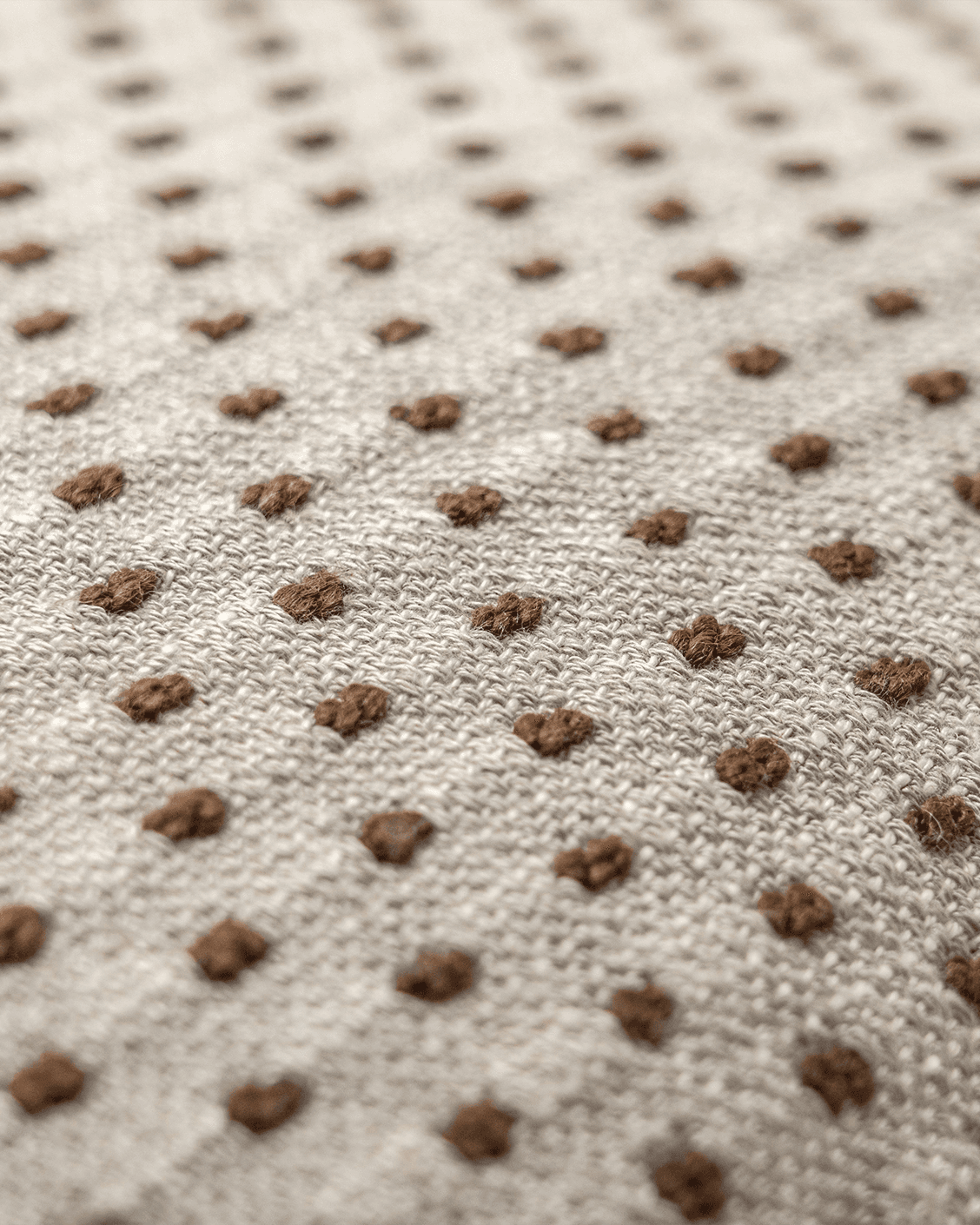 Dotty Rust III cushion in beige and grey, shown in a product close-up top view as image 5