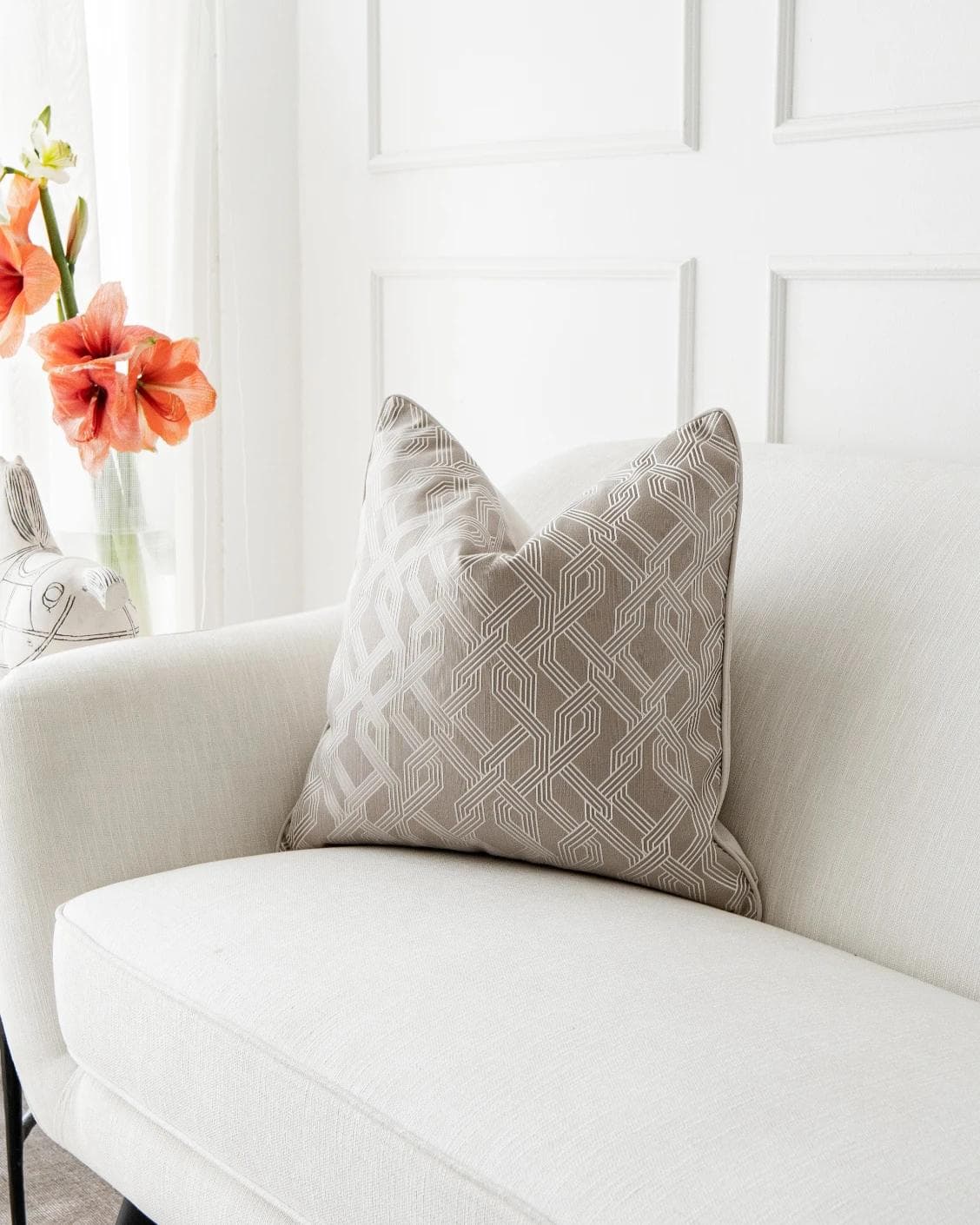 Elena Bianca cushion in beige and white, shown in a lifestyle front view as image 2