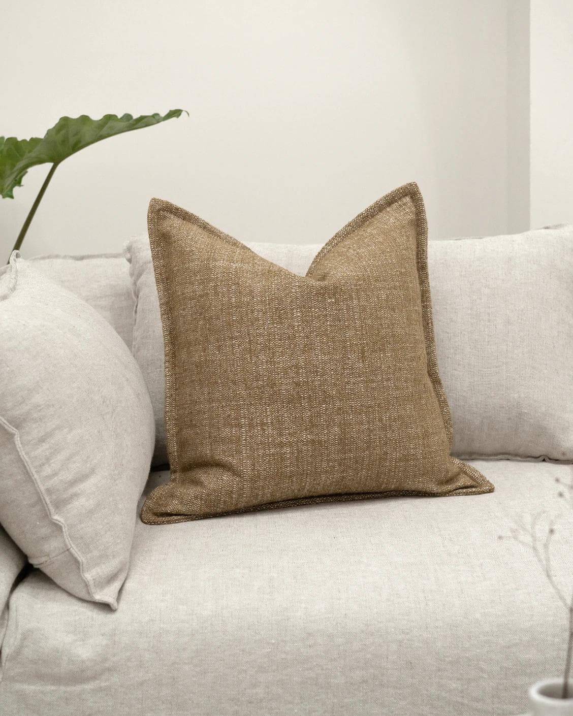 Emmett Tawna cushion in brown, shown in a lifestyle front view as image 2