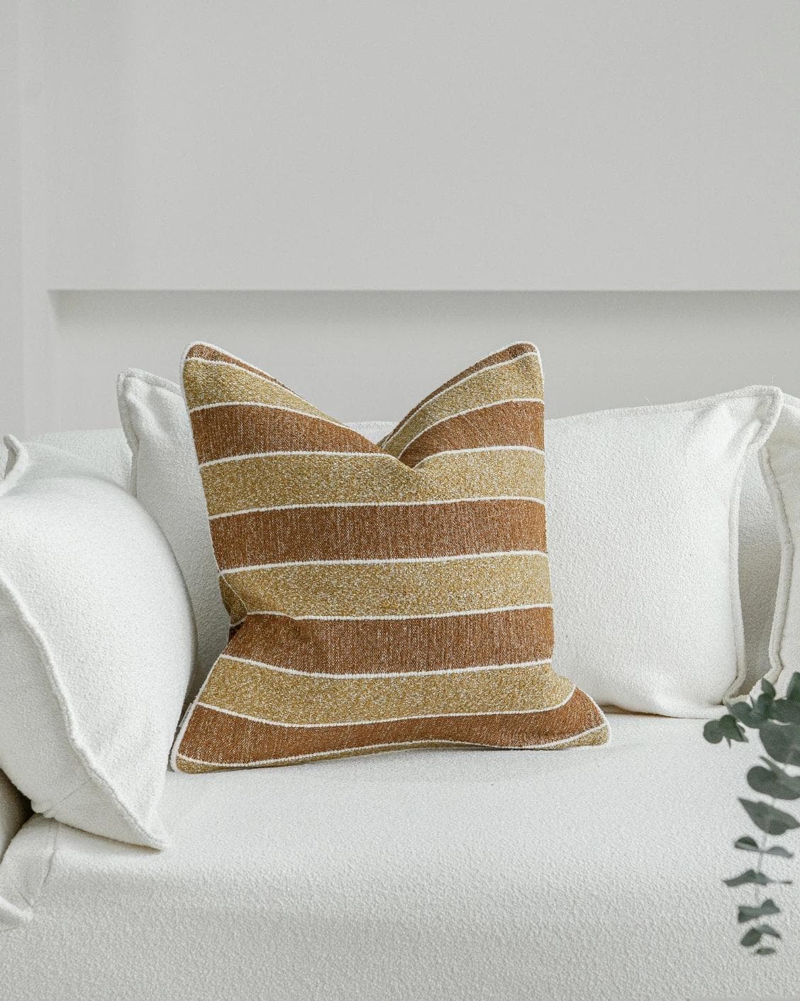 Gia Klimt cushion in brown and rust, shown in a lifestyle front view as image 2