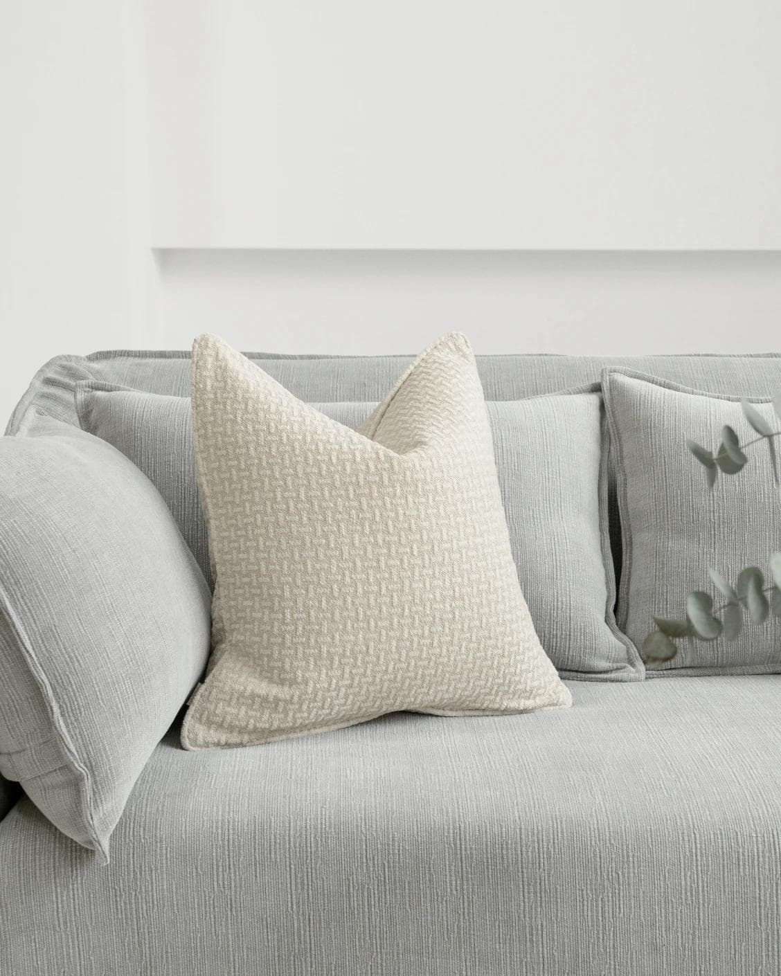 Gigi Laurent cushion in ivory, shown in a lifestyle front view as image 2