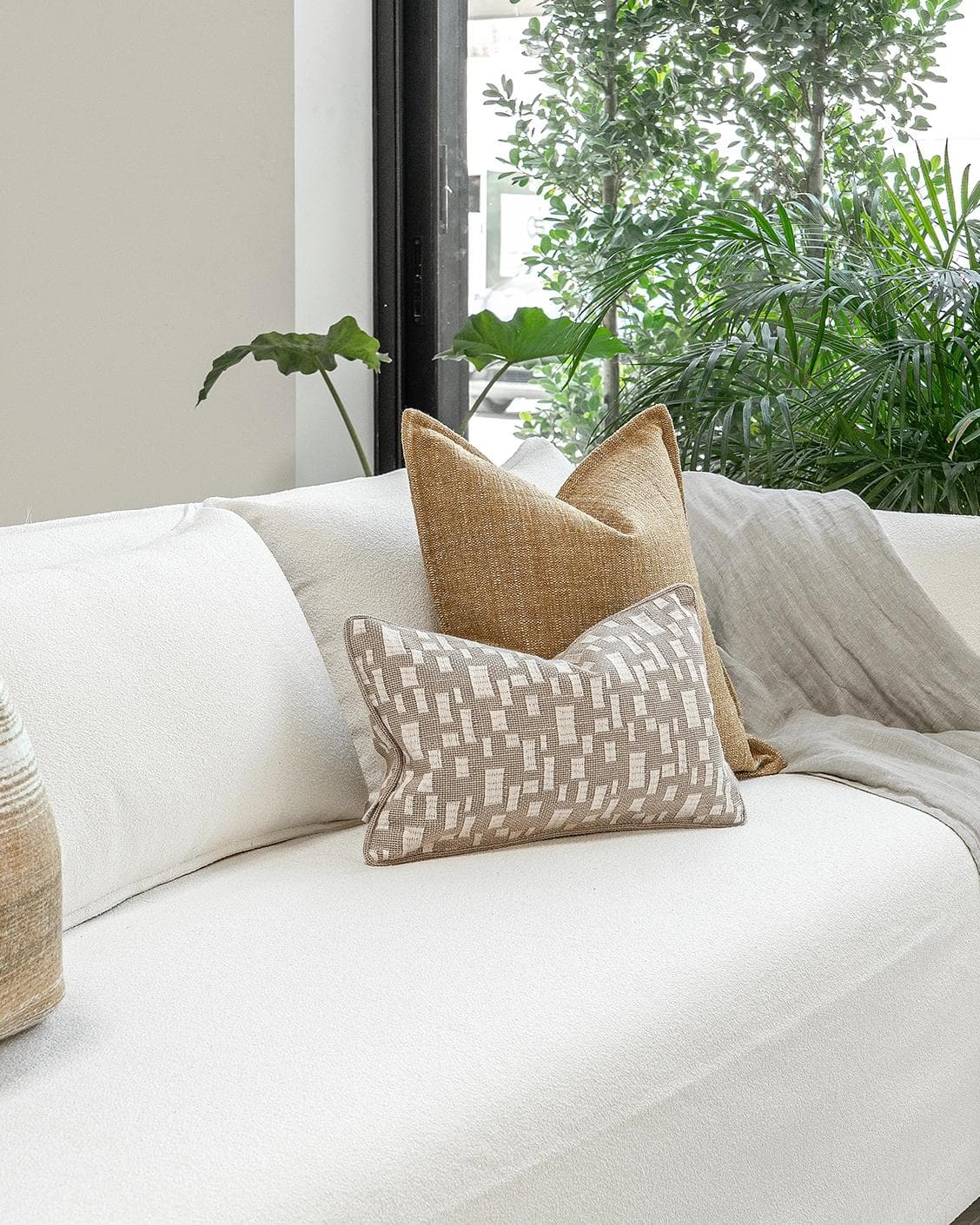 Hash Bundle cushion in beige and yellow, shown in a lifestyle left view as image 2