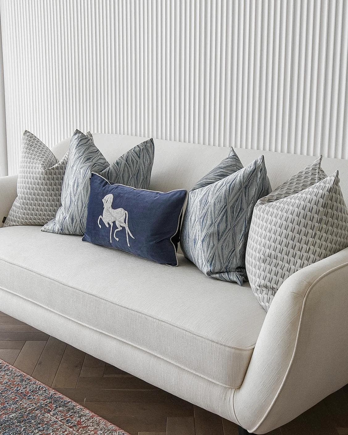 Edwin Bundle cushion in blue, silver and white, shown in a lifestyle right view as image 2