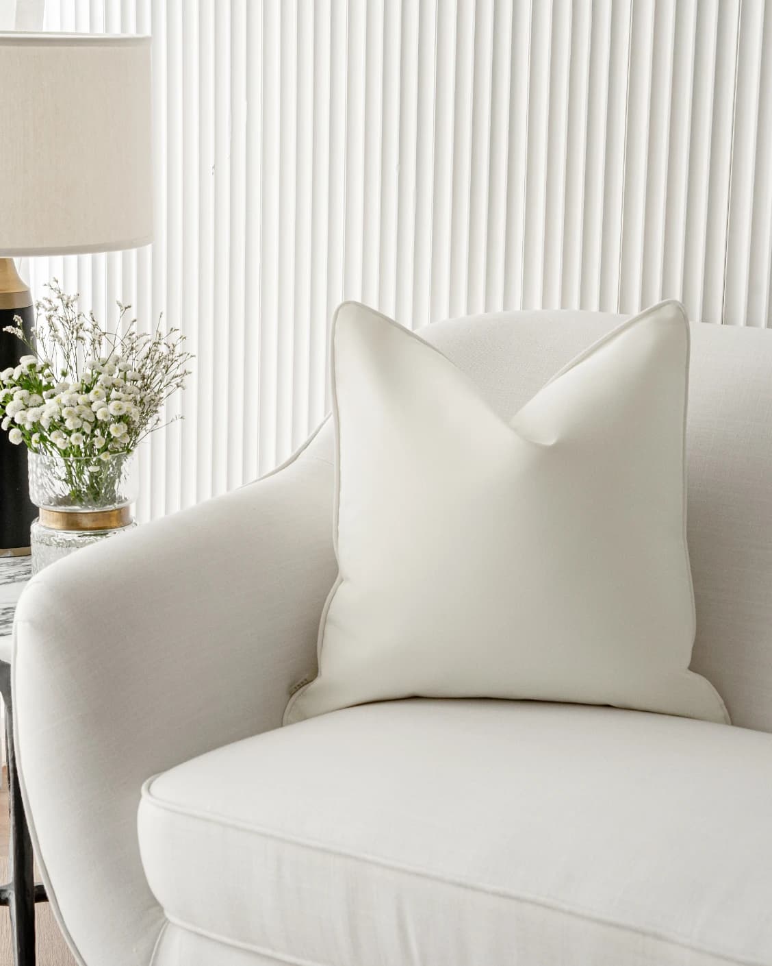 Aelia Bianca cushions in soft ivory and ivory, shown in a lifestyle front view as video image