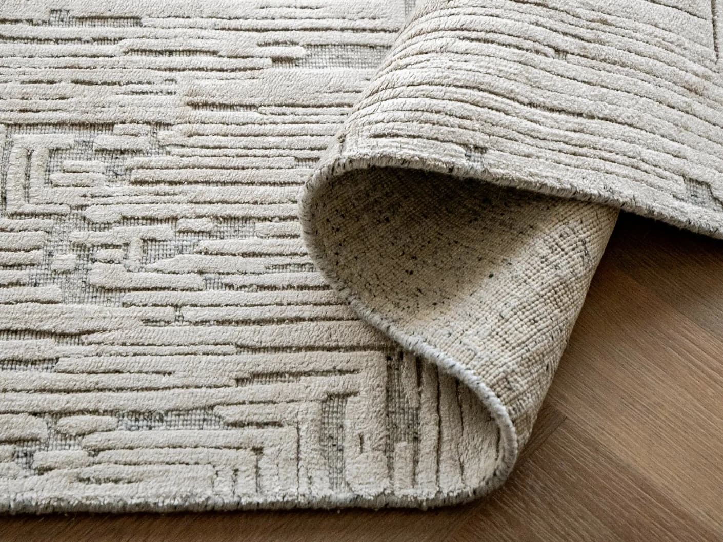 Eh Riley Stone Round carpets in stone and beige, shown in a product close-up view