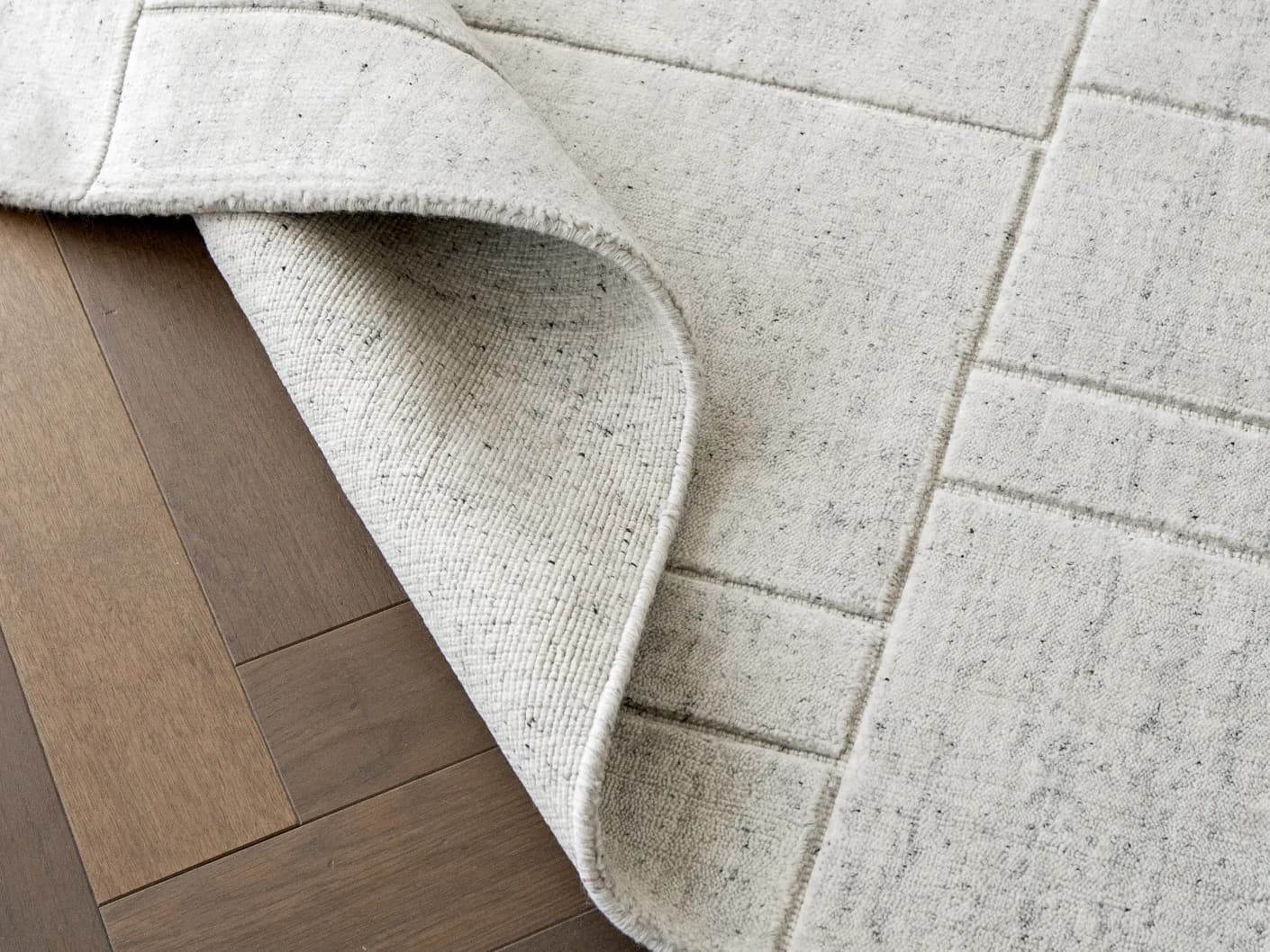 Elliot Alba carpets in grey and white, shown in a lifestyle top view