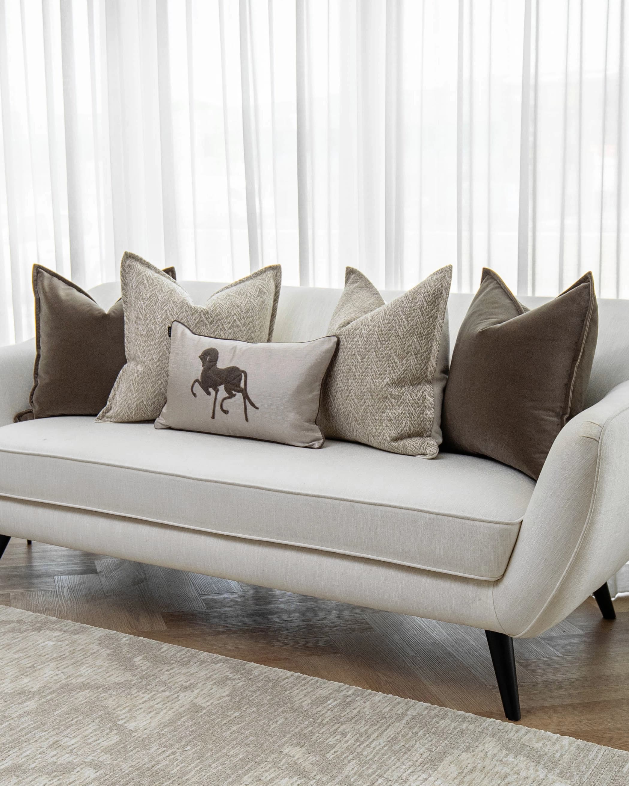 Gracia Bundle cushion in brown, shown in a lifestyle front view as image 2