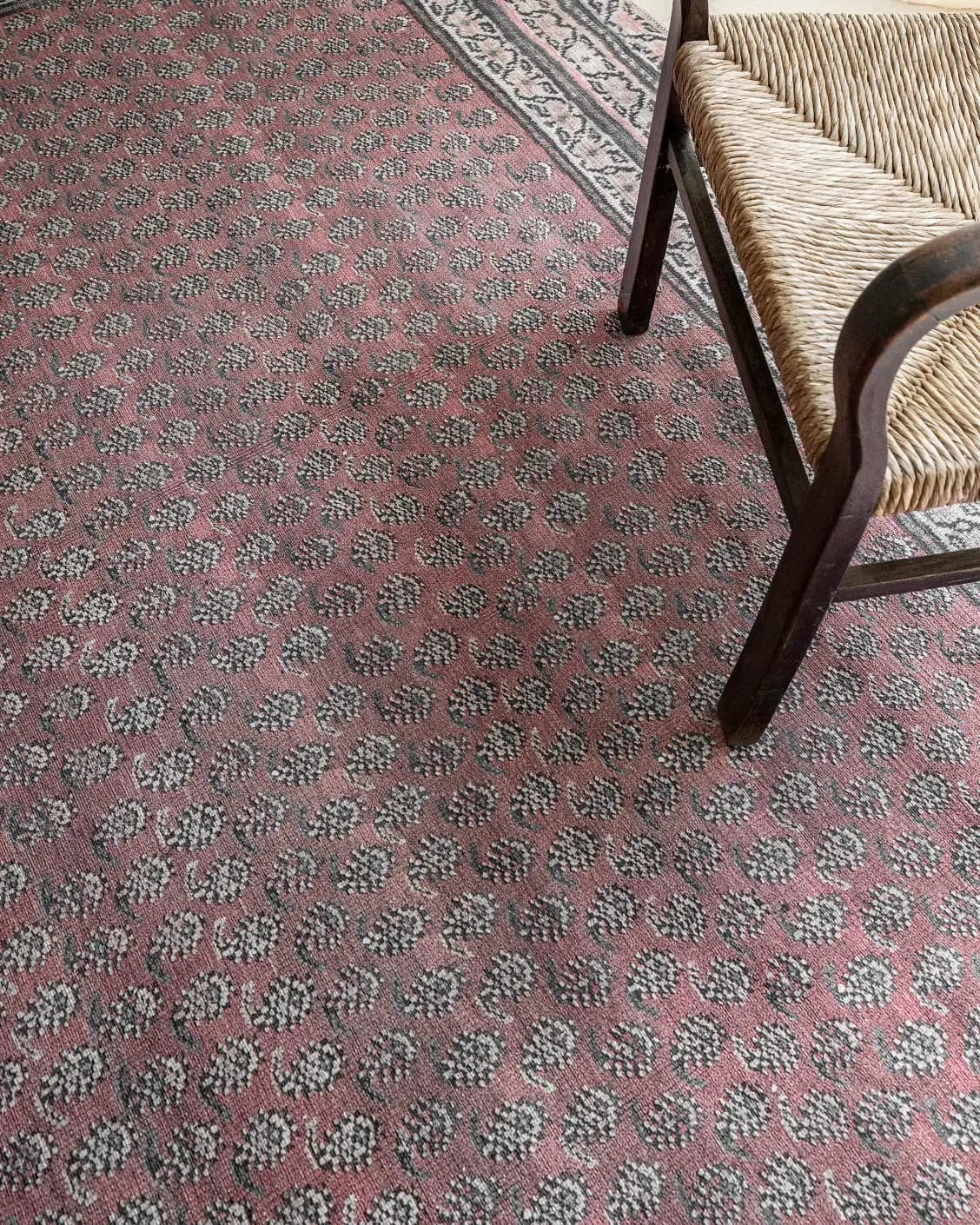 Vincent Coral carpet in coral, red and multicolour, shown in a lifestyle top view as video image