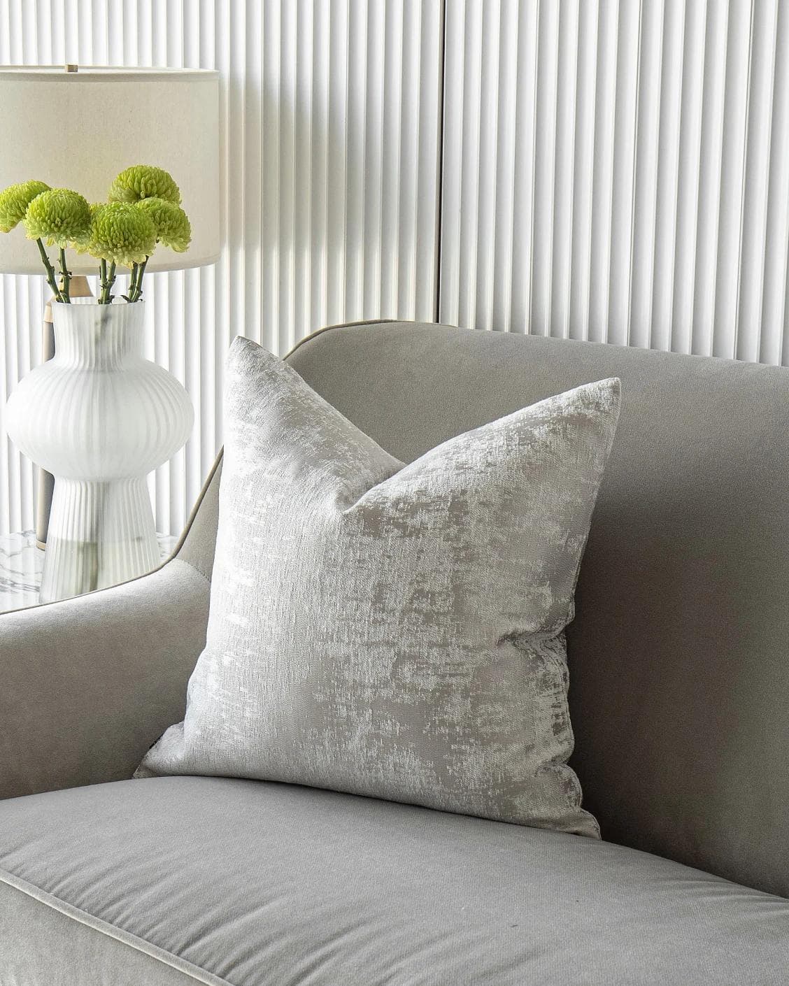 Kylie Hodler cushion in silver and grey, shown in a lifestyle front view as image 2