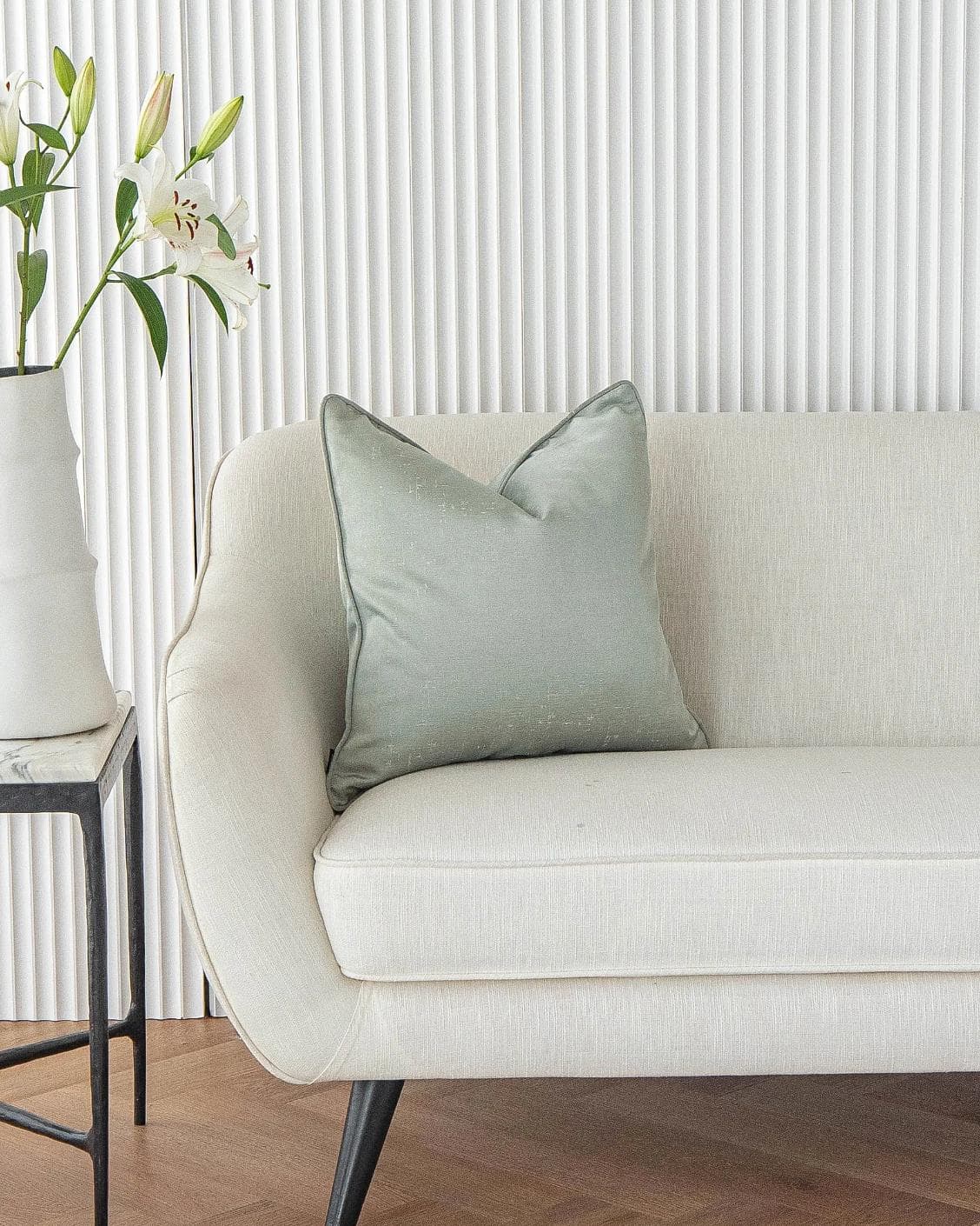 Lainie Sofia cushion in green and silver, shown in a lifestyle front view as image 4
