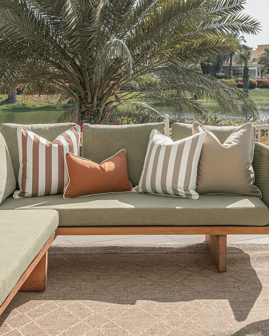 Manha Bundle cushion in rust and beige, shown in a lifestyle front view as image 4