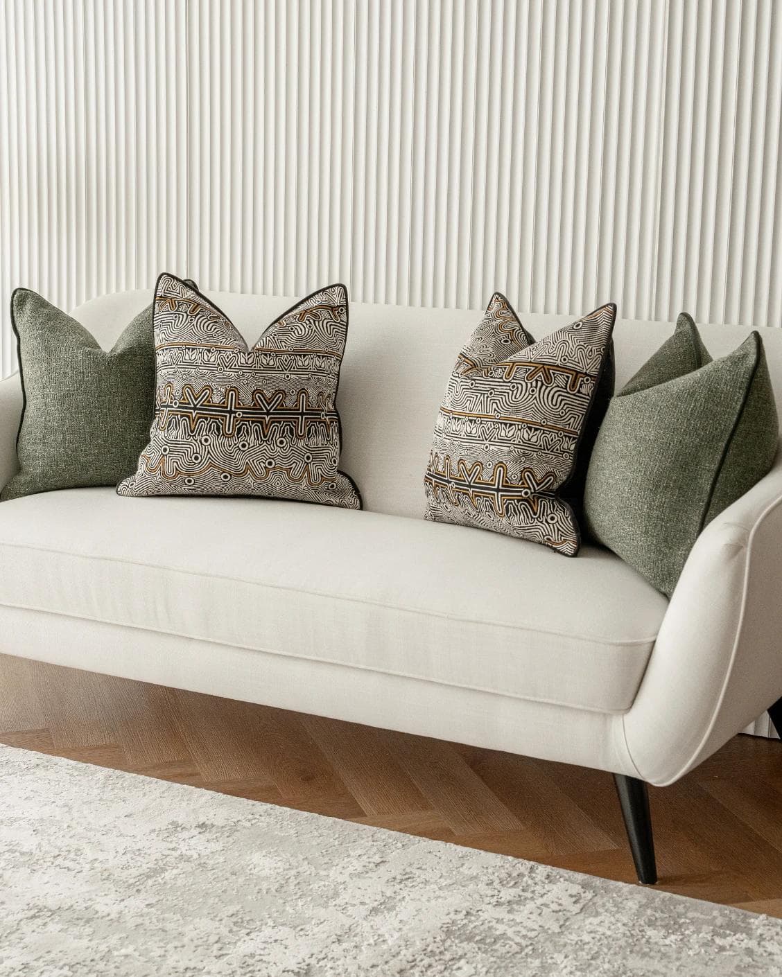 Mika Bundle cushion in black, silver and green, shown in a lifestyle right view as image 2