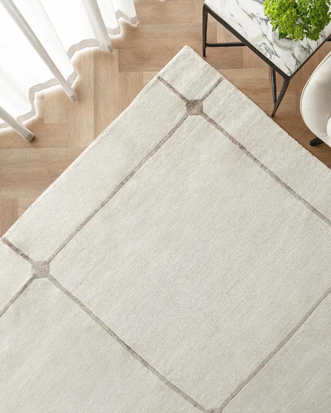 Noon Sadaf carpet in beige, shown in a lifestyle top view as image 2