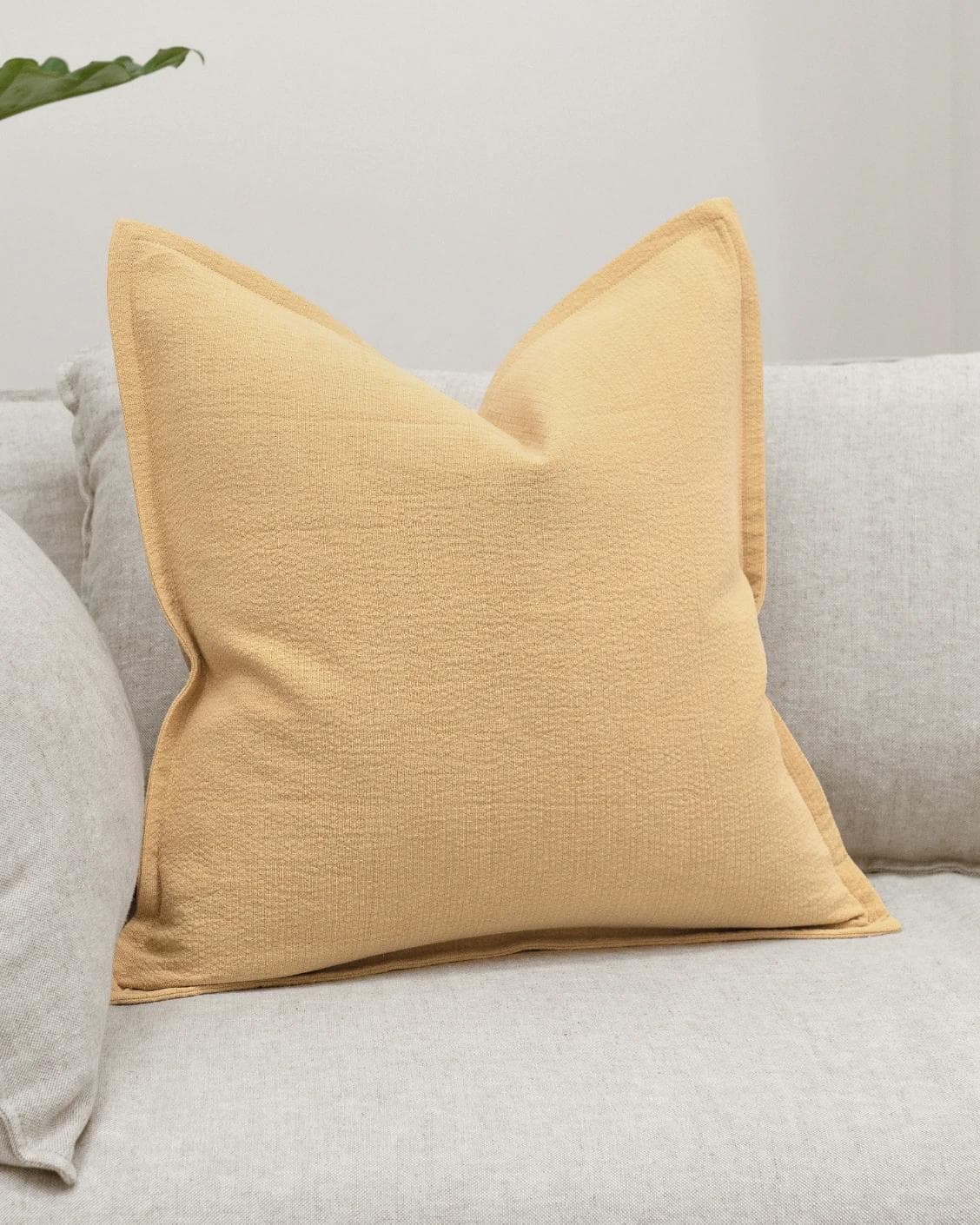 Siena Barrymore cushion in yellow, shown in a lifestyle front view as image 2
