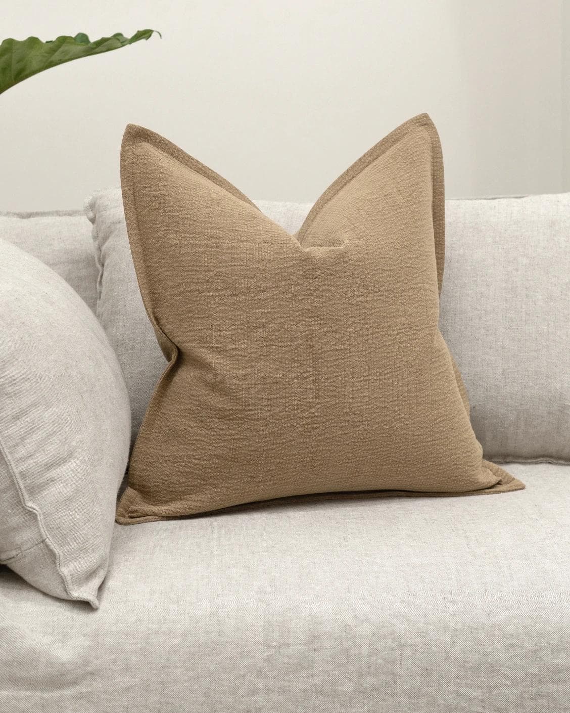 Siena Laurent cushion in brown, shown in a lifestyle front view as image 2