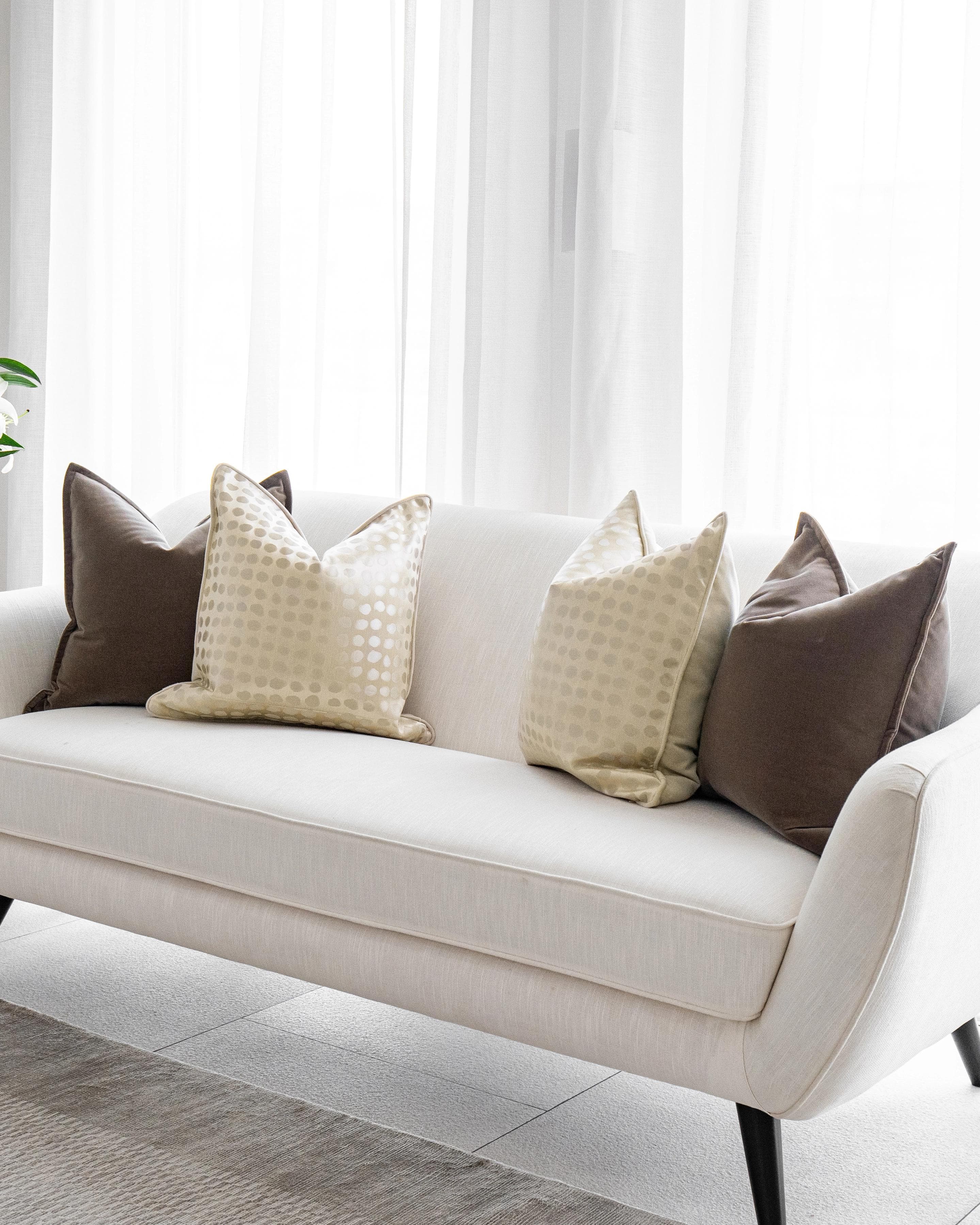 Flora Bundle cushion in brown, beige and gold, shown in a lifestyle right view as image 2