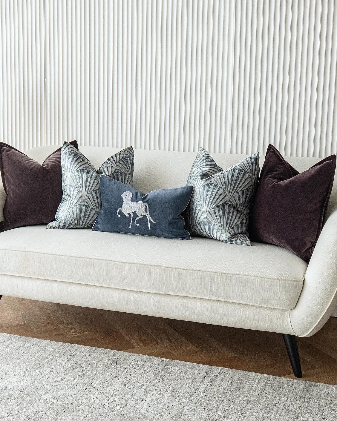 Fiavola Bundle cushion in purple, blue and silver, shown in a lifestyle right view as image 2