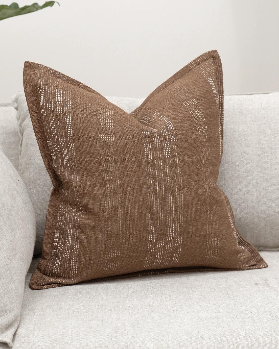 Yon Brick cushion in brown, shown in a lifestyle front view as image 2