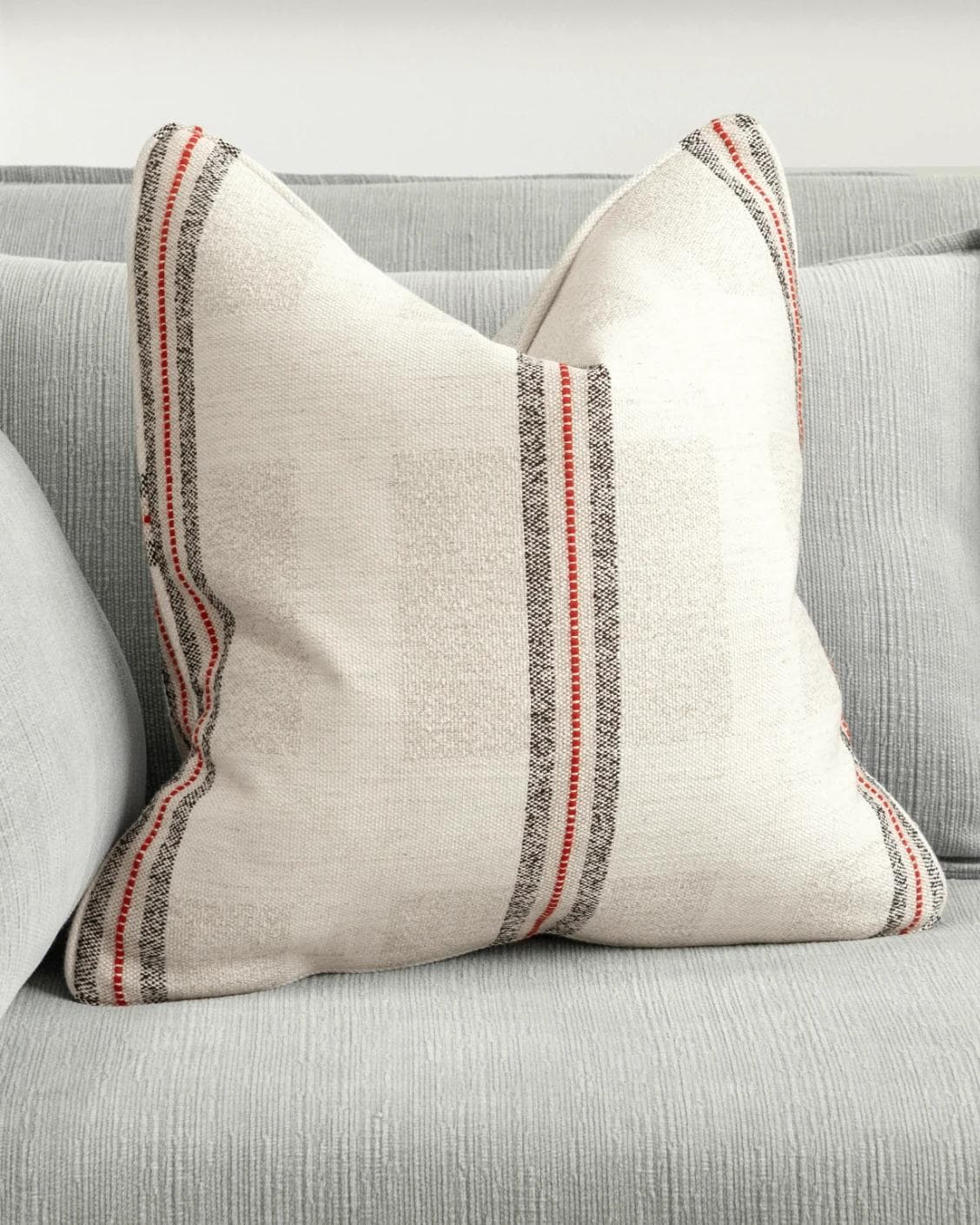 Zia Hodler cushion in multicolour and ivory, shown in a lifestyle front view as image 2